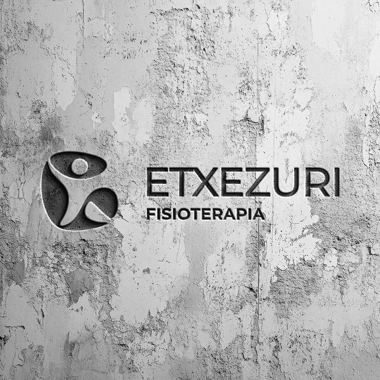 Etxezuri Fisioterapia logo embossed on a weathered concrete wall, with its figure symbol and grey lettering.