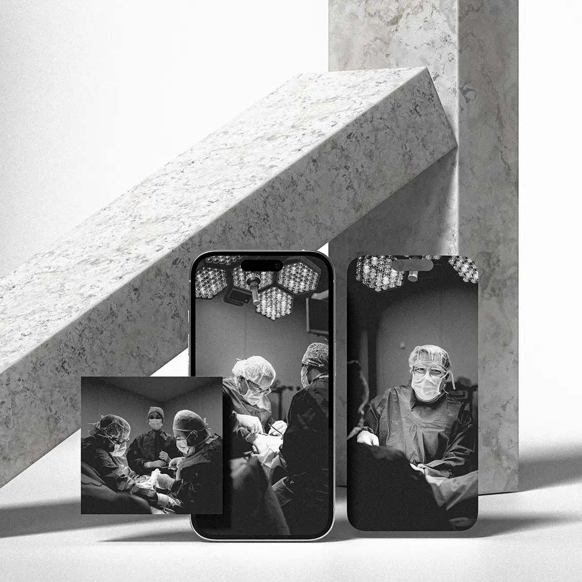 Mugisalud photo session in an operating room, black-and-white images of surgeons operating shown on phones and prints on marble.