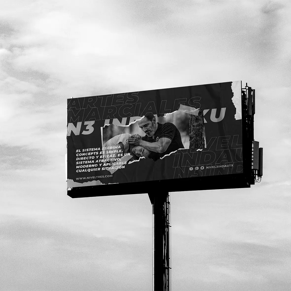 Nivel 3 Indautxu martial arts billboard against a cloudy sky, with a black-and-white self-defence photograph and copy.